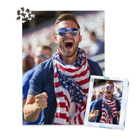 1000 piece 4th of July photo puzzle featuring a cheering man wearing an American flag scarf, shown with its matching puzzle box