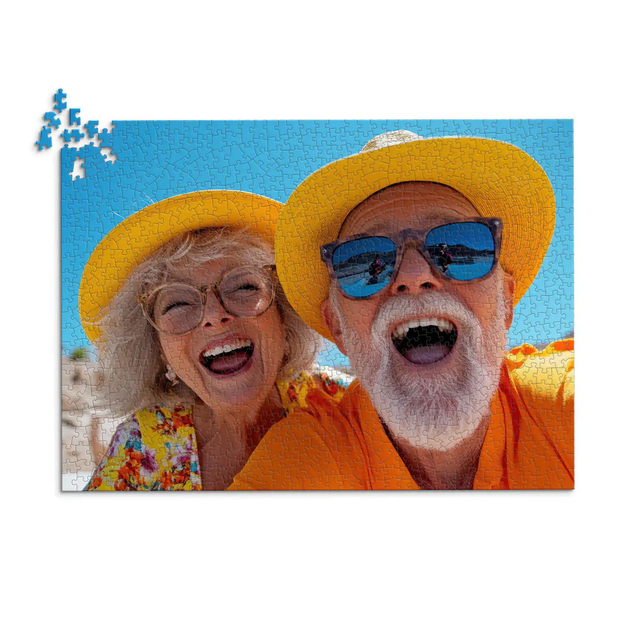 1000 piece personalized couple puzzle featuring a joyful older couple wearing sun hats at the beach.