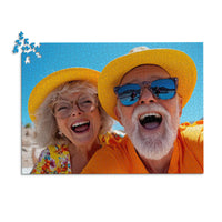 1000 piece personalized couple puzzle featuring a joyful older couple wearing sun hats at the beach.