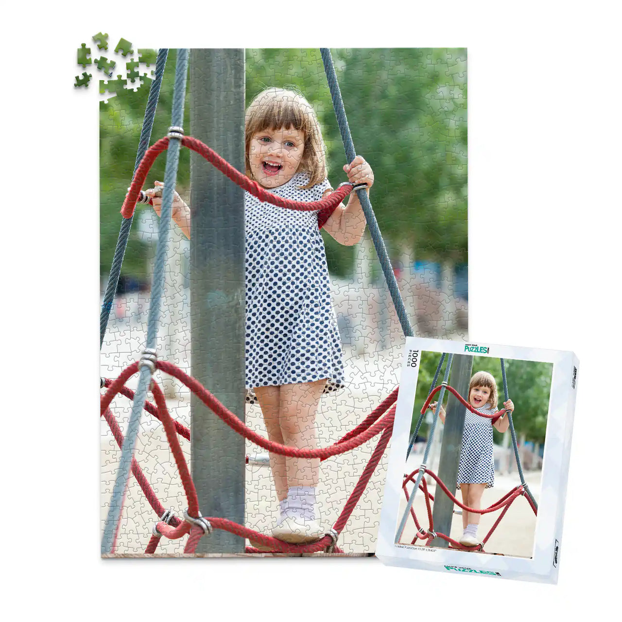 1000 piece personalized puzzle for kids showing a smiling young girl climbing playground ropes, displayed with the matching puzzle box.
