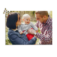 1000 piece personalized puzzle for new parents showing a smiling mother and father holding their baby outdoors.