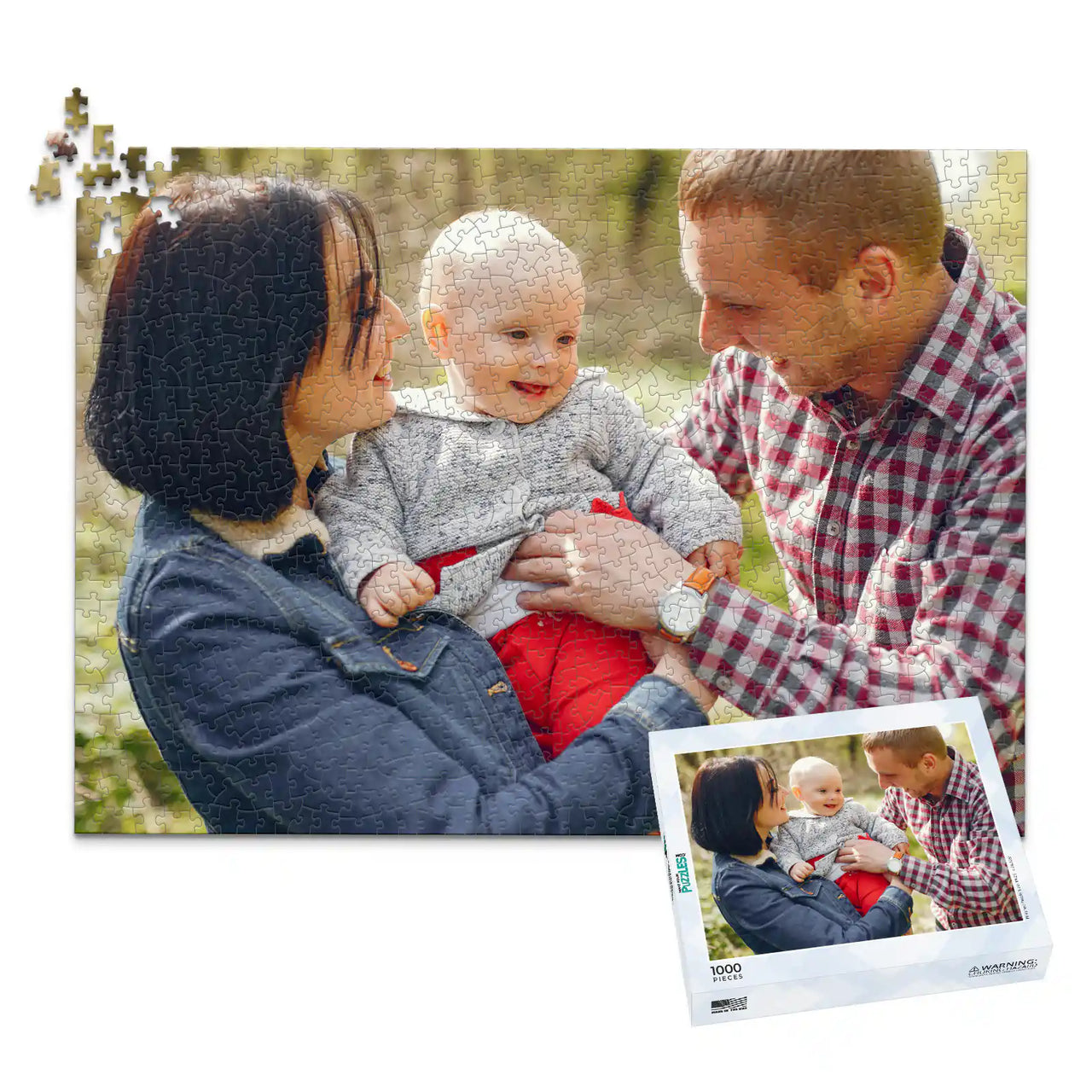 1000 piece personalized puzzle for new parents showing a smiling mother and father holding their baby outdoors, displayed with the matching puzzle box.