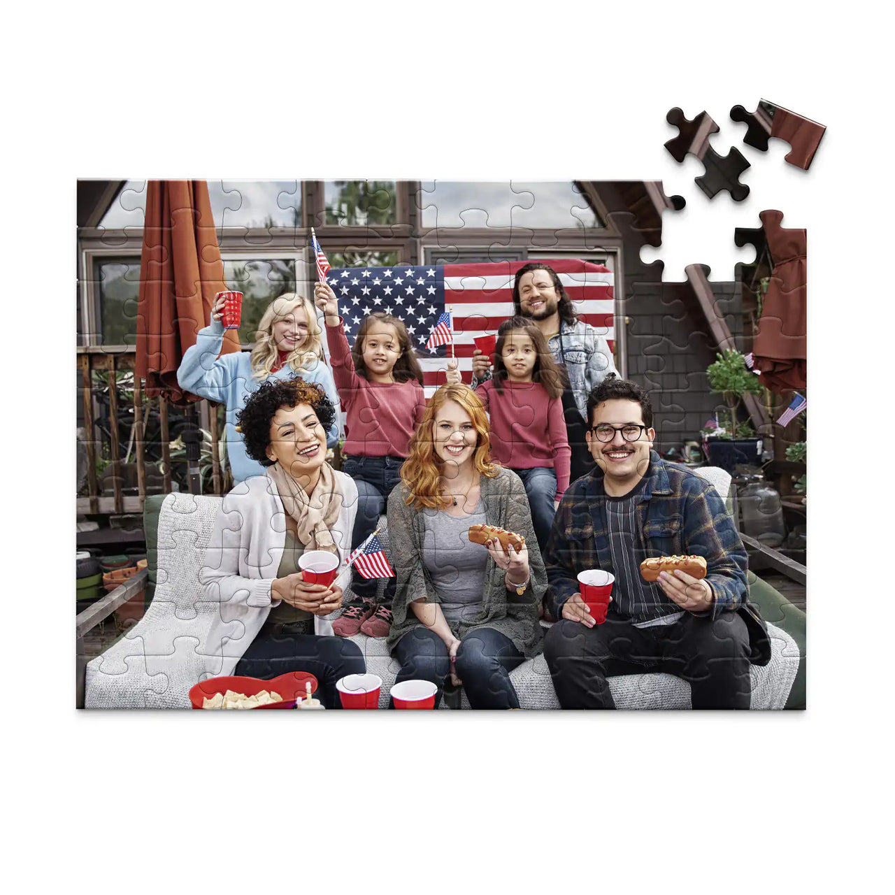 100 piece 4th of July photo puzzle featuring a family celebrating with American flags and hot dogs.