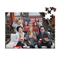 100 piece 4th of July photo puzzle featuring a family celebrating with American flags and hot dogs.