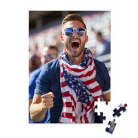 100 piece 4th of July photo puzzle featuring a cheering man wearing an American flag scarf.