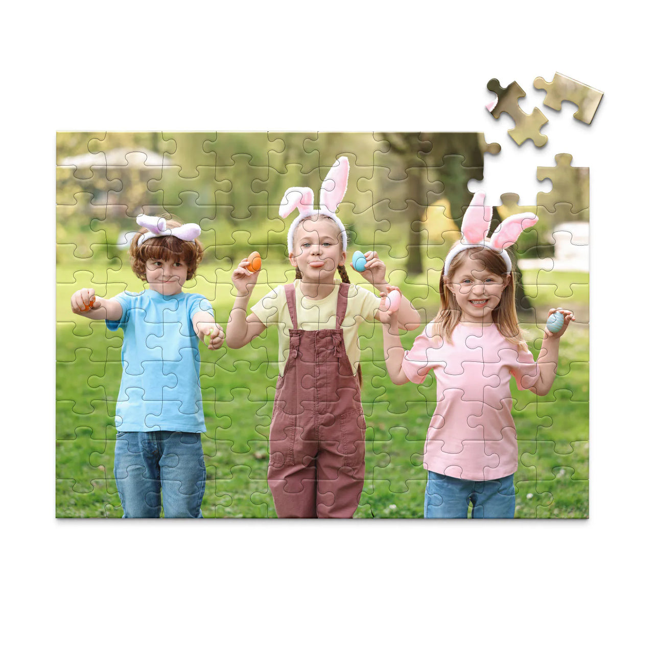 100 piece Easter photo puzzle featuring three children wearing bunny ears and holding colorful Easter eggs.