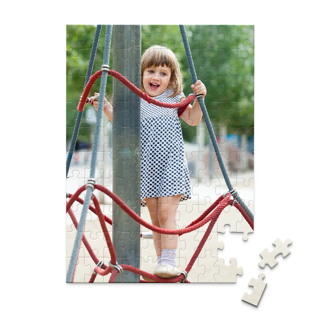 100 piece personalized puzzle for kids showing a smiling young girl climbing playground ropes.