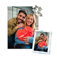 100 piece personalized Valentine puzzle featuring a smiling couple with a heart-shaped gift, shown with its matching puzzle box