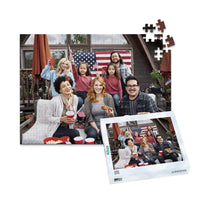 252 piece 4th of July photo puzzle featuring a family celebrating with American flags and hot dogs, shown with its matching puzzle box