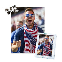 252 piece 4th of July photo puzzle featuring a cheering man wearing an American flag scarf, shown with its matching puzzle box