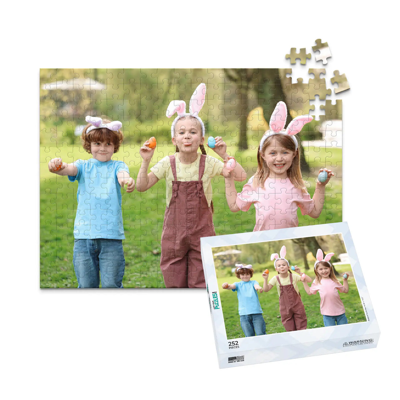 252 piece Easter photo puzzle featuring three children wearing bunny ears and holding colorful Easter eggs, shown with its matching puzzle box