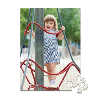 252 piece personalized puzzle for kids showing a smiling young girl climbing playground ropes.