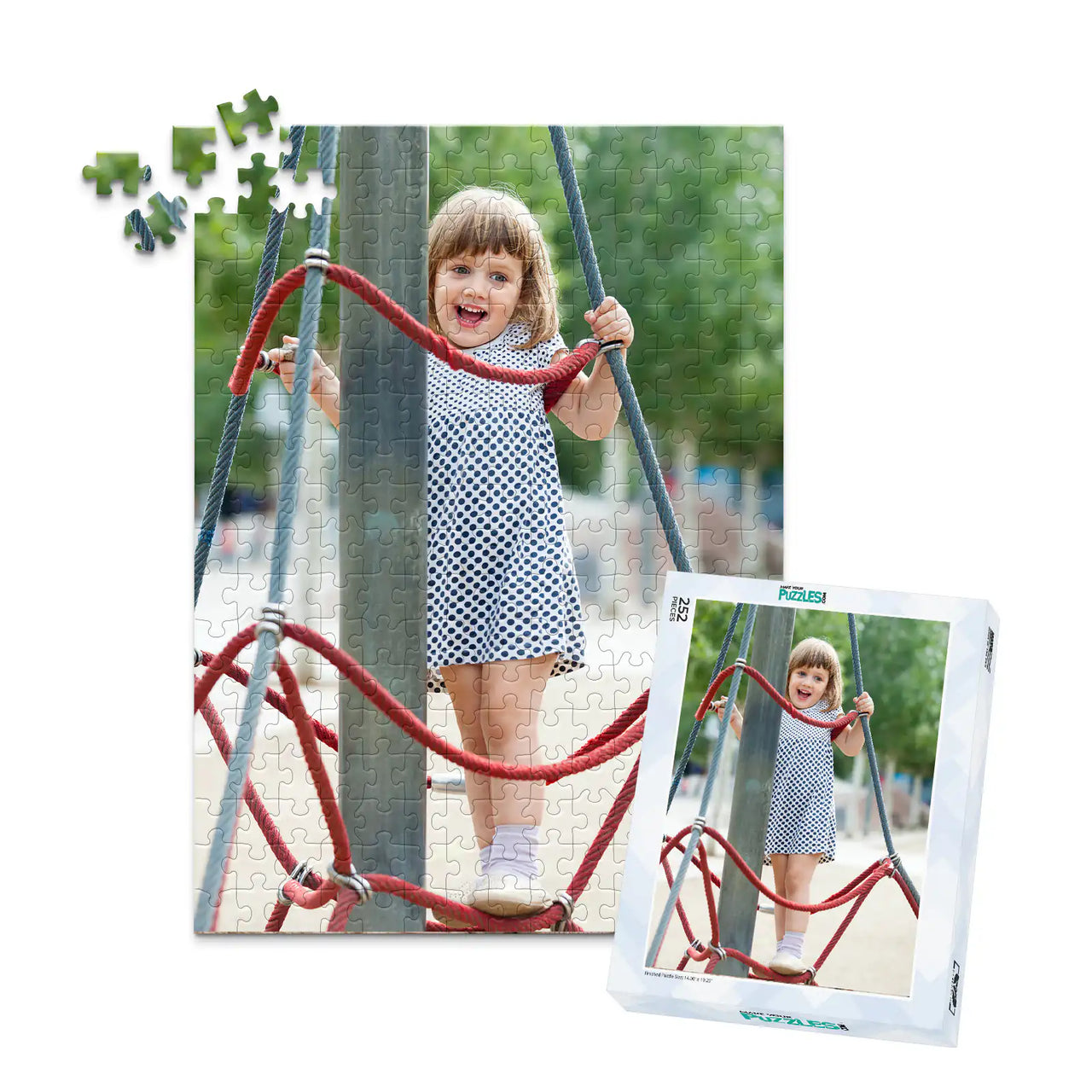 252 piece personalized puzzle for kids showing a smiling young girl climbing playground ropes, displayed with the matching puzzle box.