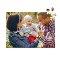 252 piece personalized puzzle for new parents showing a smiling mother and father holding their baby outdoors.