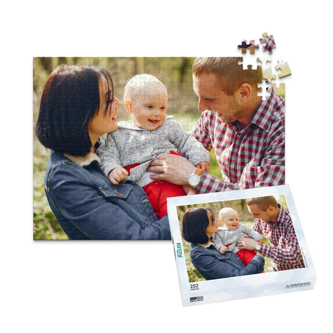 252 piece personalized puzzle for new parents showing a smiling mother and father holding their baby outdoors, displayed with the matching puzzle box.