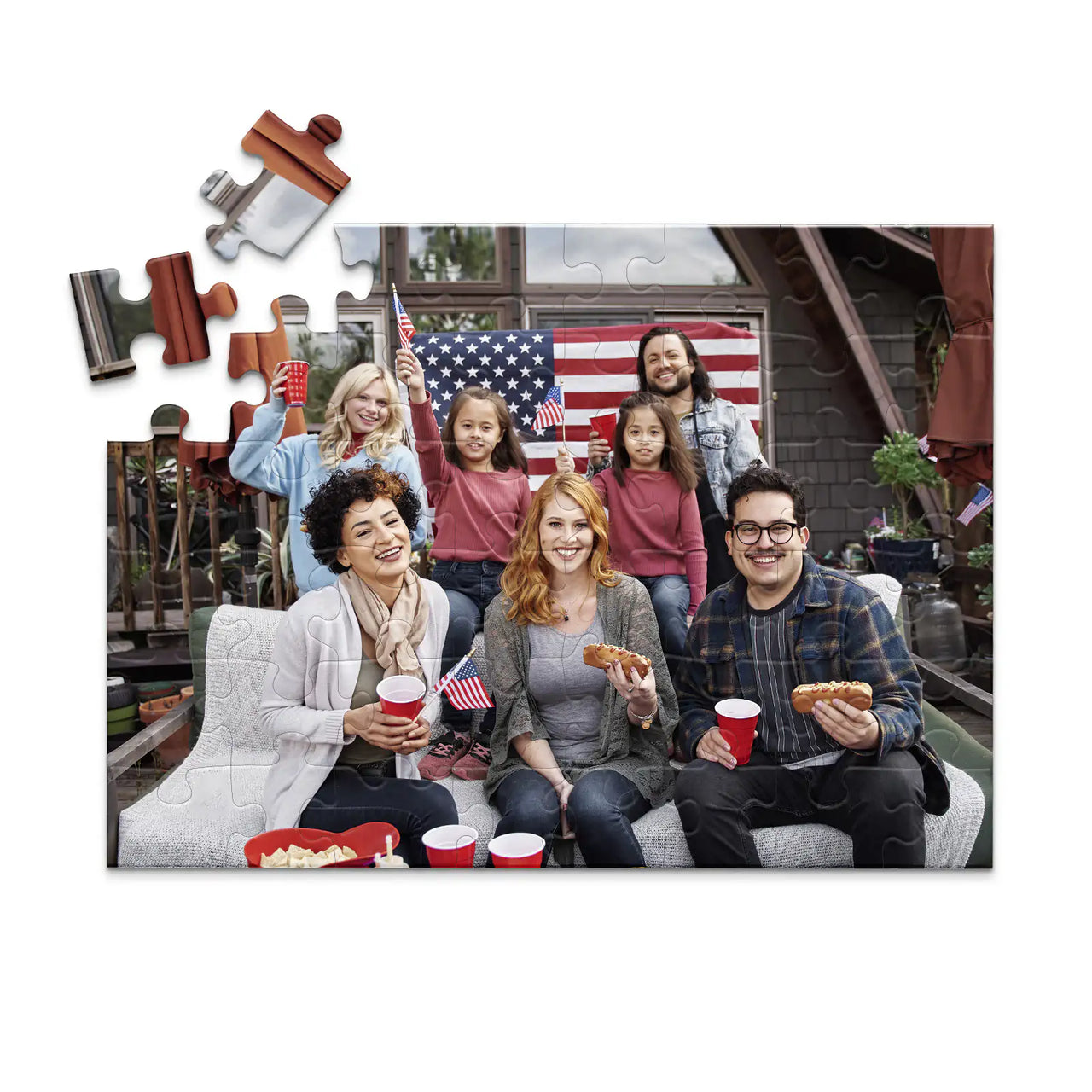 48 piece 4th of July photo puzzle featuring a family celebrating with American flags and hot dogs.