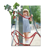 48 piece personalized puzzle for kids showing a smiling young girl climbing playground ropes.