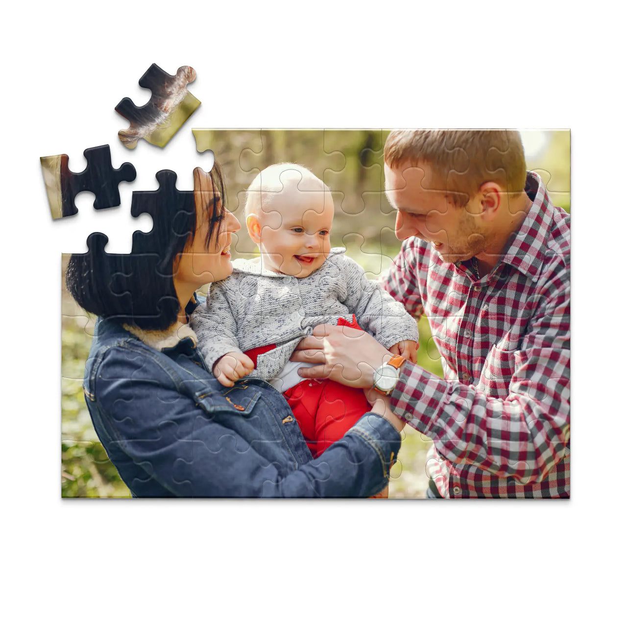 48 piece personalized puzzle for new parents showing a smiling mother and father holding their baby outdoors.