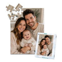 48 piece personalized puzzle for new parents showing a smiling mother and father with their baby, displayed with the matching puzzle box.