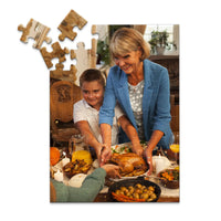 48 piece Thanksgiving photo puzzle featuring a grandmother and grandson serving turkey at a family dinner.