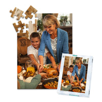 48 piece Thanksgiving photo puzzle featuring a grandmother and grandson serving turkey at a family dinner, shown with its matching puzzle box