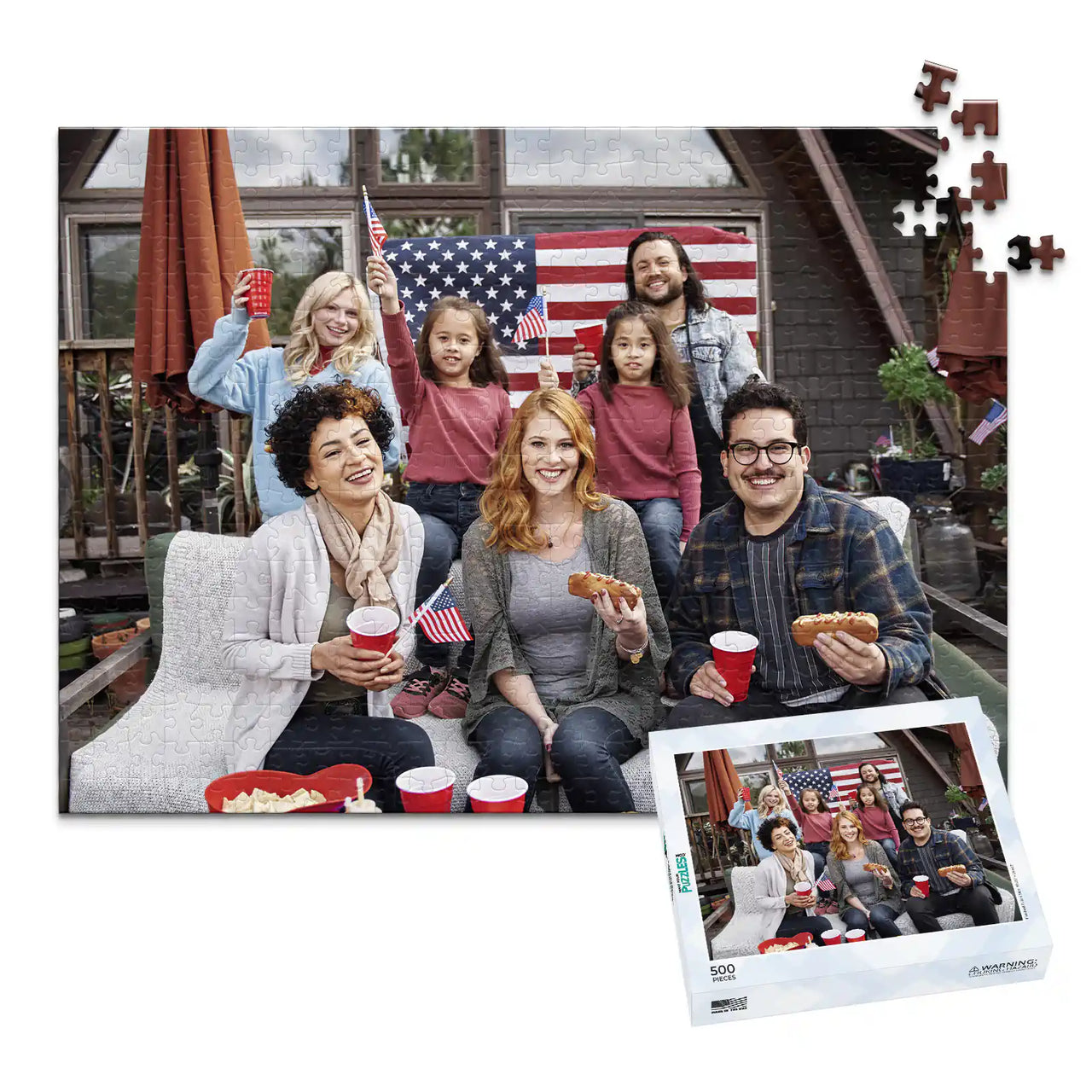 500 piece 4th of July photo puzzle featuring a family celebrating with American flags and hot dogs, shown with its matching puzzle box