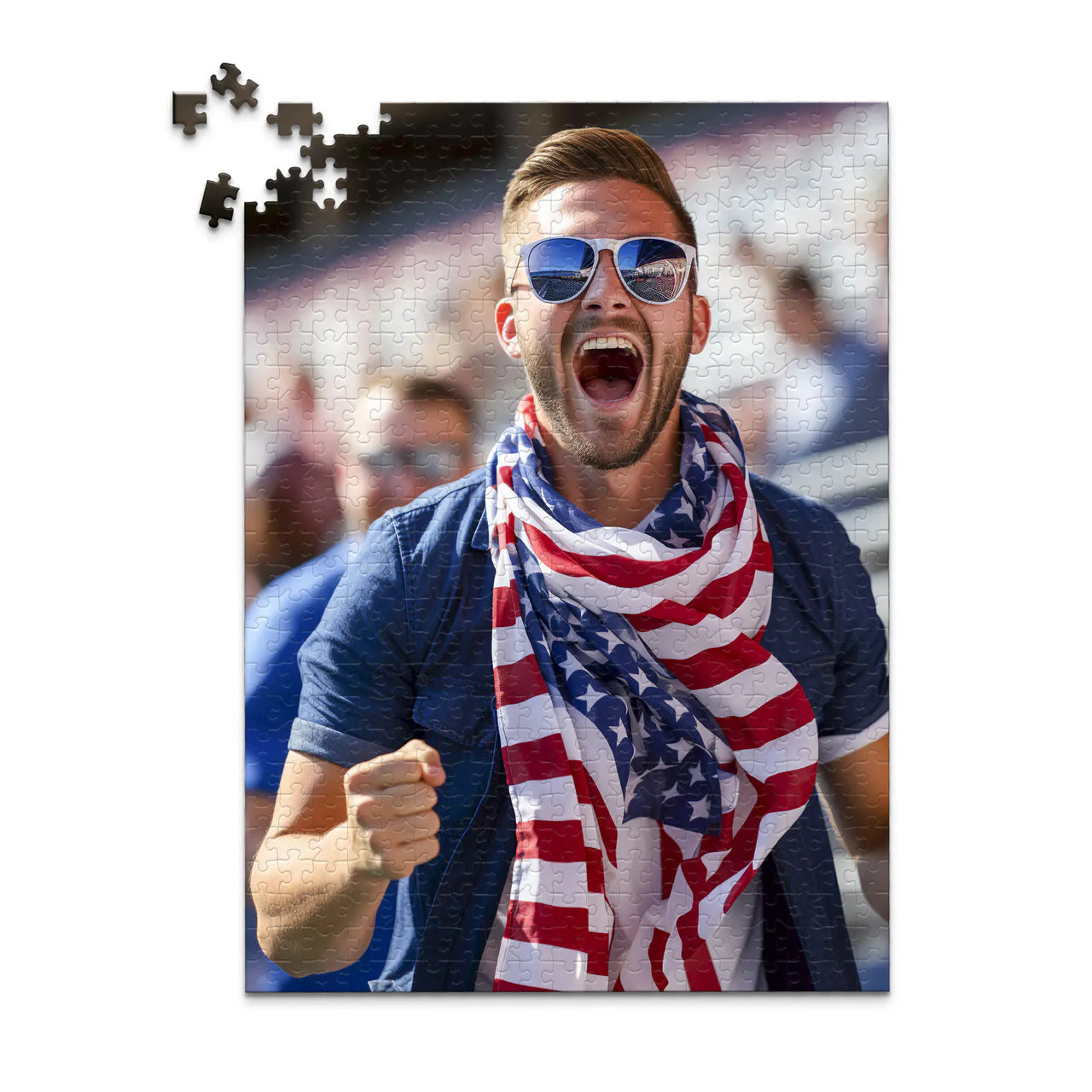500 piece 4th of July photo puzzle featuring a cheering man wearing an American flag scarf.