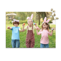 500 piece Easter photo puzzle featuring three children wearing bunny ears and holding colorful Easter eggs.