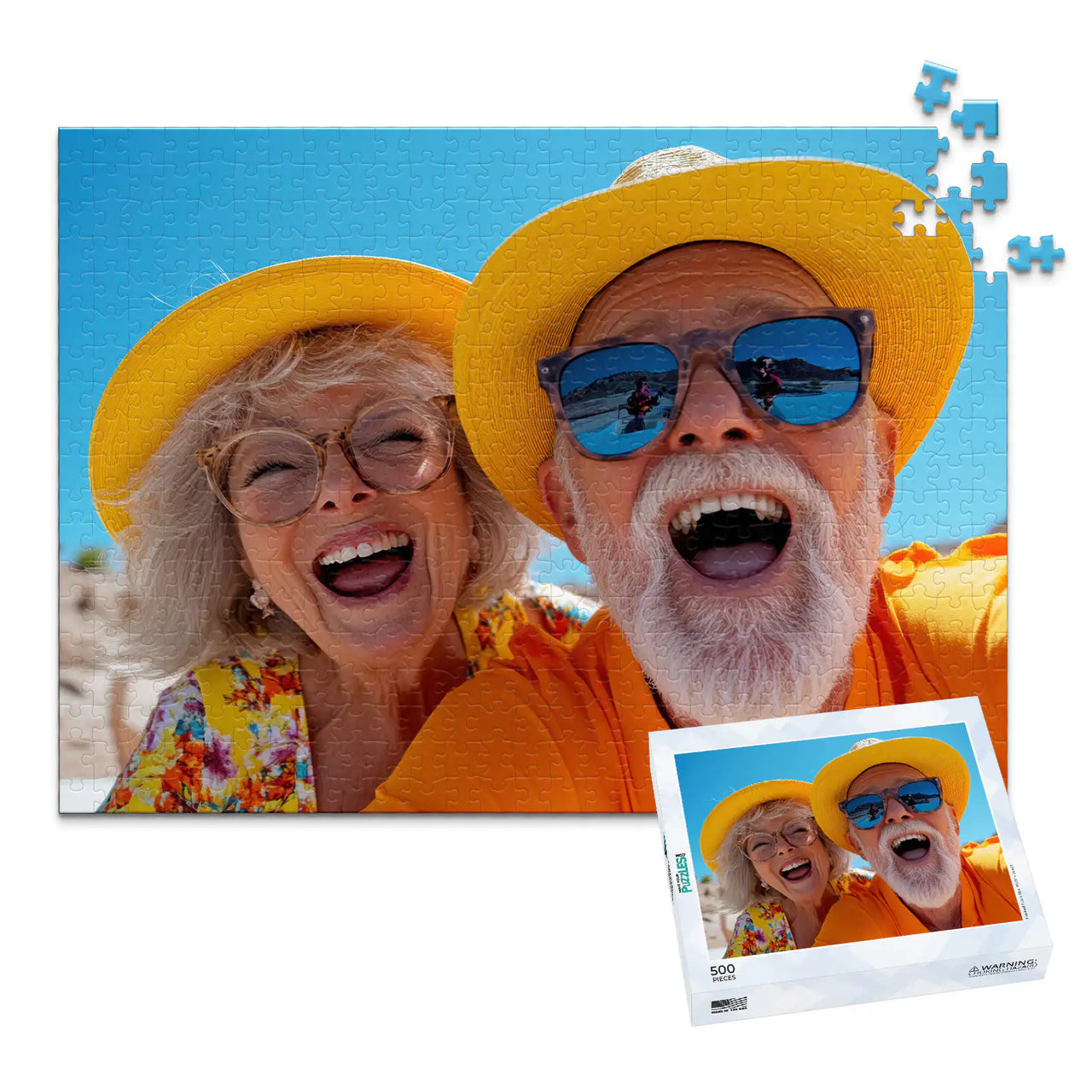 500 piece personalized couple puzzle featuring a joyful older couple wearing sun hats at the beach, shown with its matching puzzle box