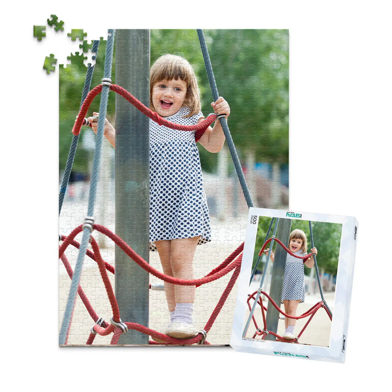 500 piece personalized puzzle for kids showing a smiling young girl climbing playground ropes, displayed with the matching puzzle box.