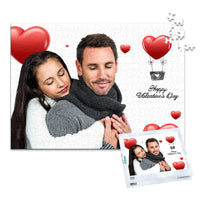 500 piece personalized Valentine puzzle featuring a couple embracing with heart decorations, shown with its matching puzzle box