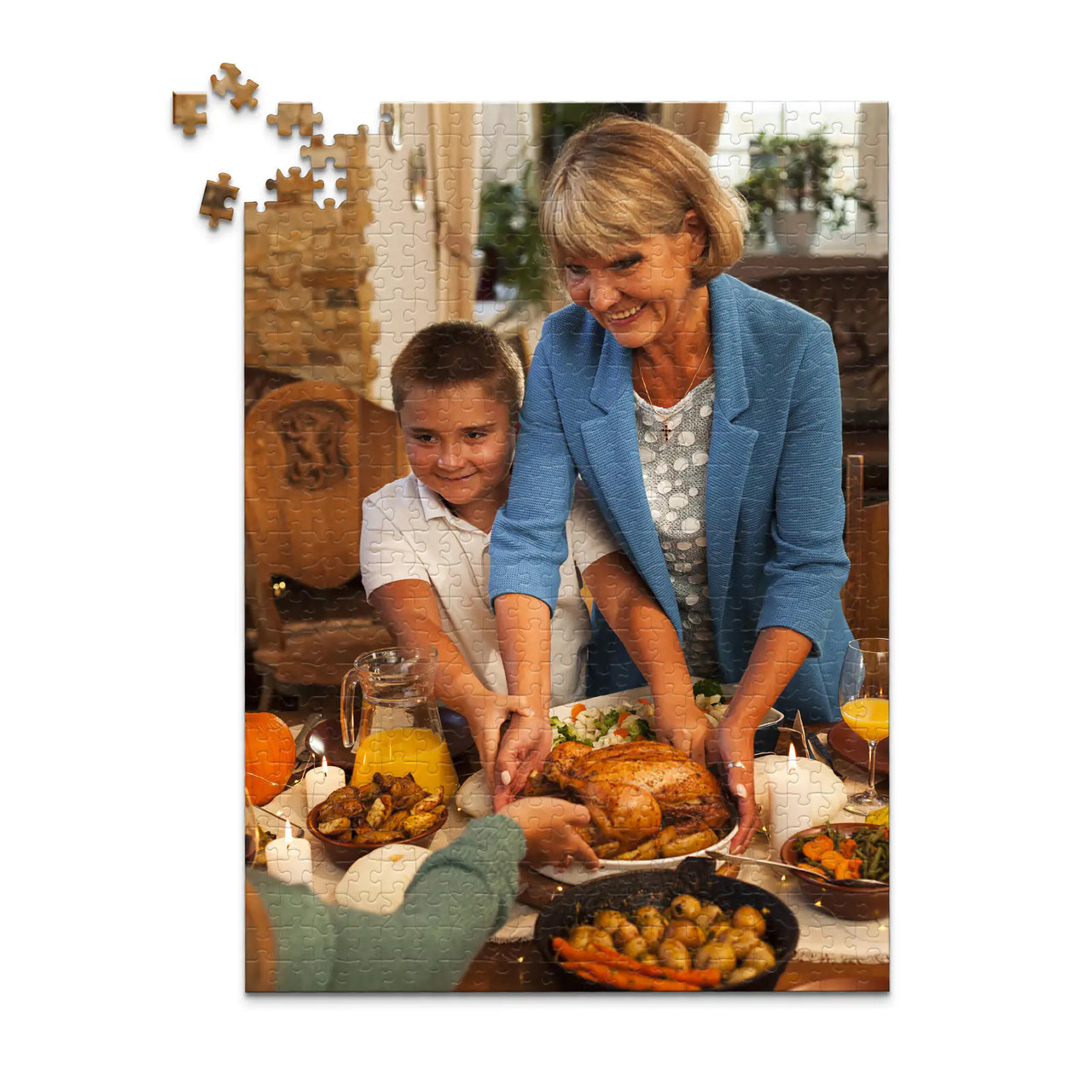 500 piece Thanksgiving photo puzzle featuring a grandmother and grandson serving turkey at a family dinner.