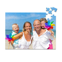Custom Travel Photo Puzzle 100 piece showing a family with two young kids on a beach with blue sky