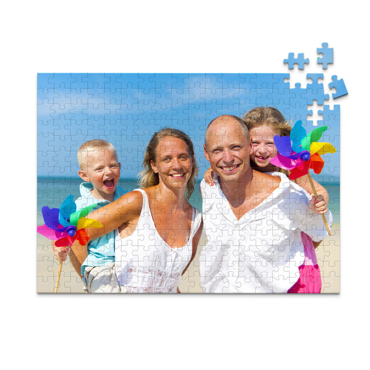 Custom Travel Photo Puzzle 252 piece showing a family with two young kids on a beach with blue sky