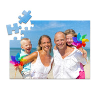 Custom Travel Photo Puzzle 48 piece showing a family with two young kids on a beach with blue sky