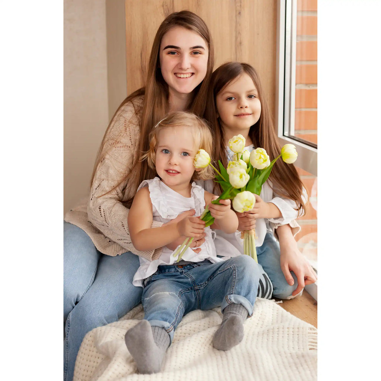 Custom Mother’s Day Puzzle featuring a portrait of a smiling mother and her two daughters holding pale yellow tulips.
