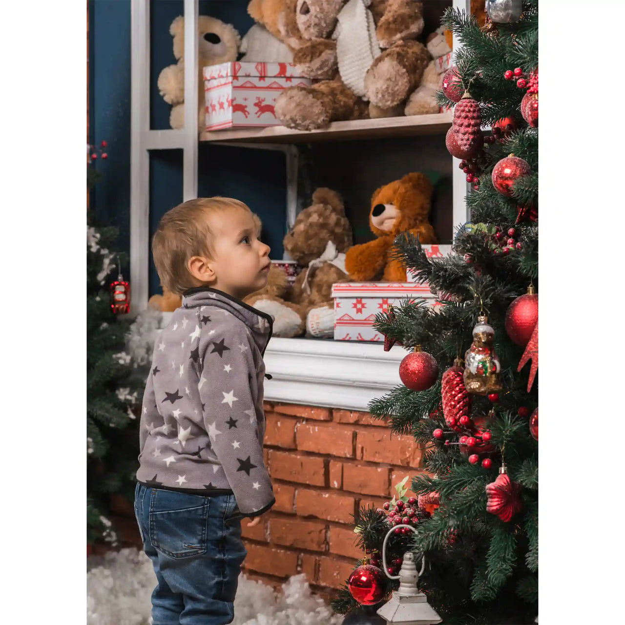 Personalized Christmas Puzzle Portrait orientation of a young child wearing a gray star-patterned fleece jacket and blue jeans stands in front of a decorated Christmas tree and shelf with teddy bears.